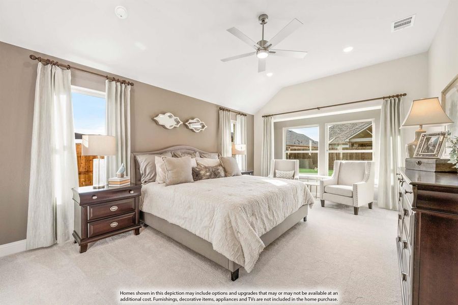 Master bedroom with vaulted ceiling, ceiling fan, carpet floors, and large windows with natural light