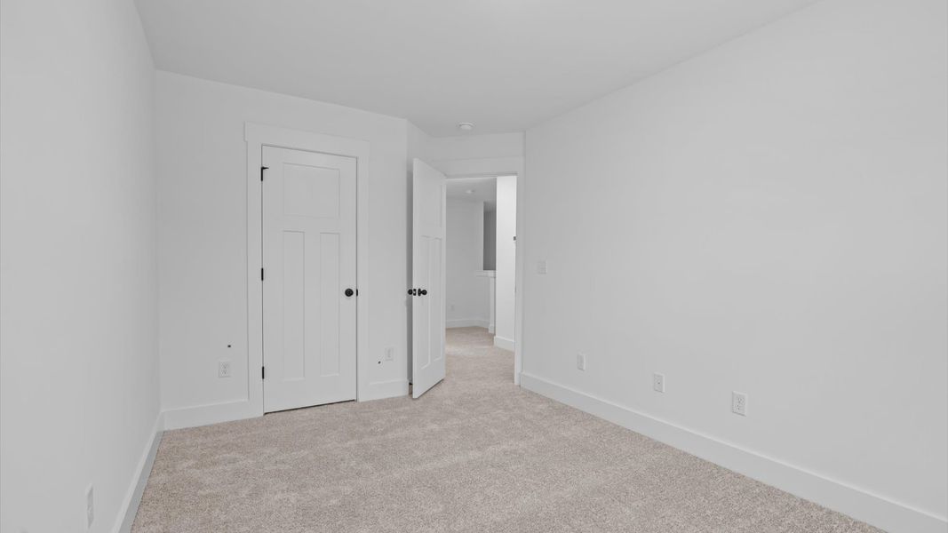 Accomplished design shines in this carpeted bedroom with a functional walk-in closet Accomplished design shines in this carpeted bedroom with a functional walk-in closet