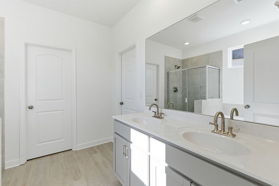 A bathroom with a large mirror.