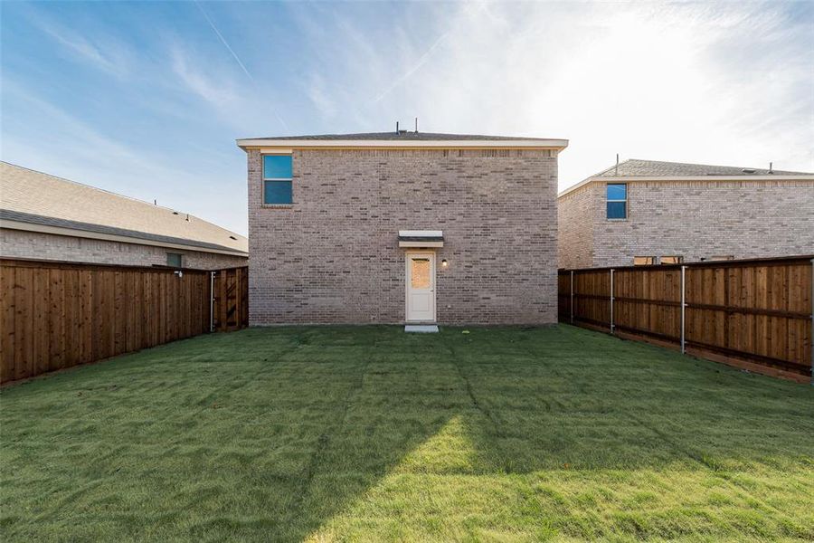 Rear view of house with a lawn