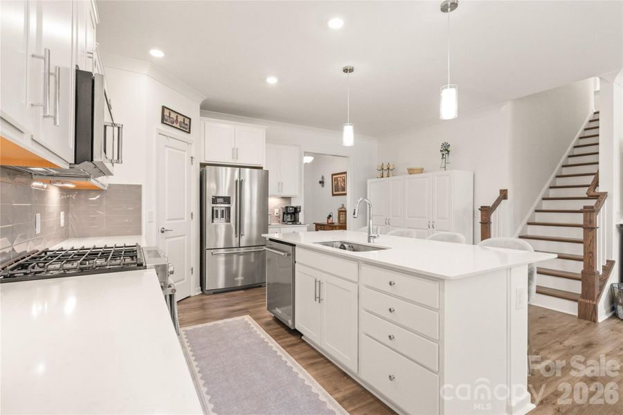 Pendant lighting already installed adds a nice touch. Additional cabinetry on the far wall is not attached and does not convey.