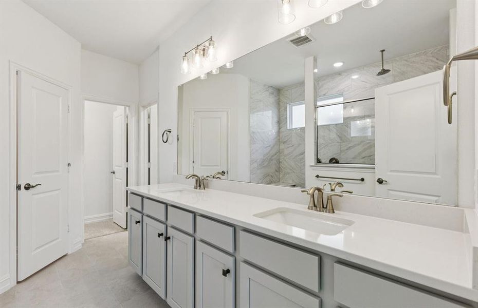 Modern owner's bath with dual vanities and a spacious shower *Real home pictured Modern owner's bath with dual vanities and a spacious shower *Real home pictured