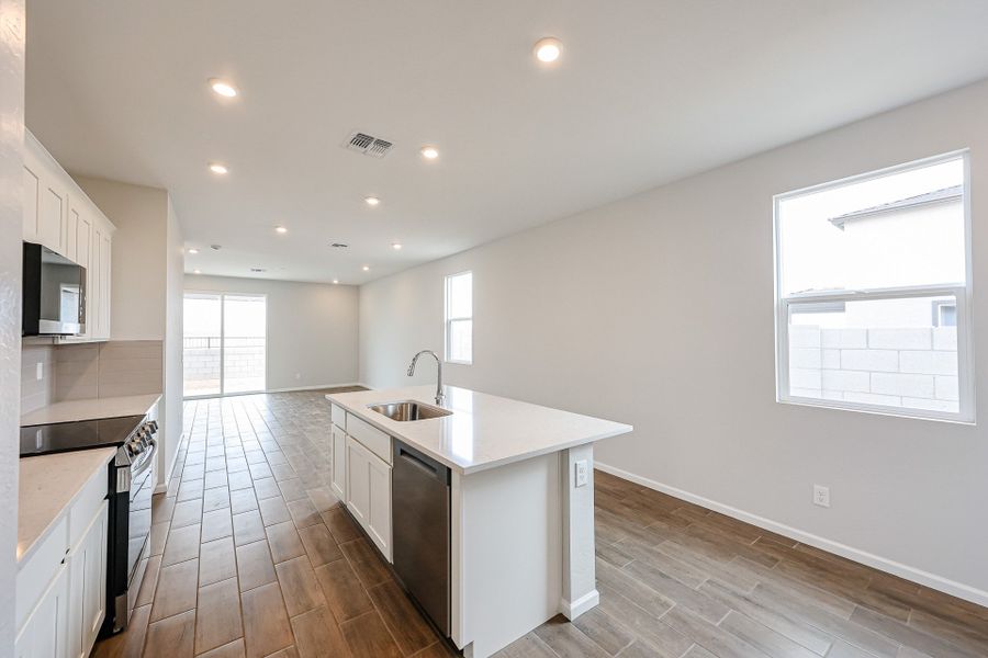 A kitchen with a wood floor.