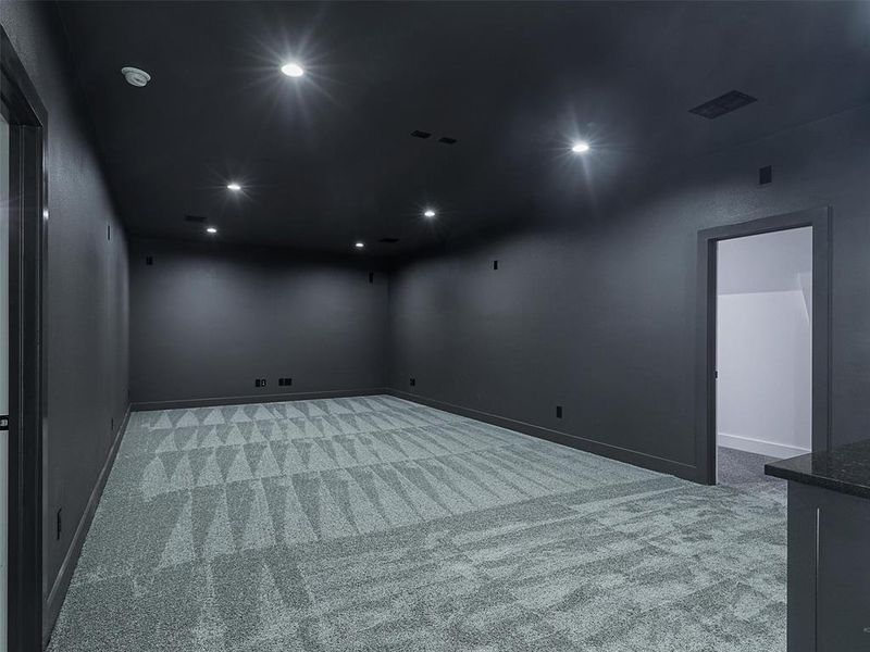 Sound proofed media room complete with a built-in bar & refrigerator-ready space, offers the perfect place to entertain.