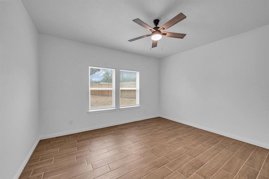 Spare room with ceiling fan and light wood-type flooring