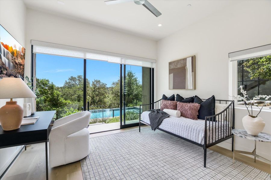 Room featuring full-height sliding glass doors, a window, a contemporary ceiling fan, and light wood-finish flooring