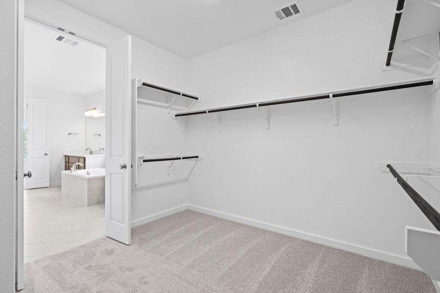 Walk-in closet in Primary Bedroom Walk-in closet in Primary Bedroom
