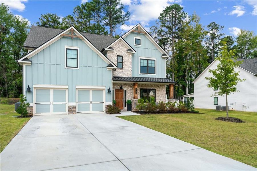 Front exterior of a new home in Springside Reserve, Powder Springs, GA, highlighting curb appeal (Image 27). Front exterior of a new home in Springside Reserve, Powder Springs, GA, highlighting curb appeal (Image 27).