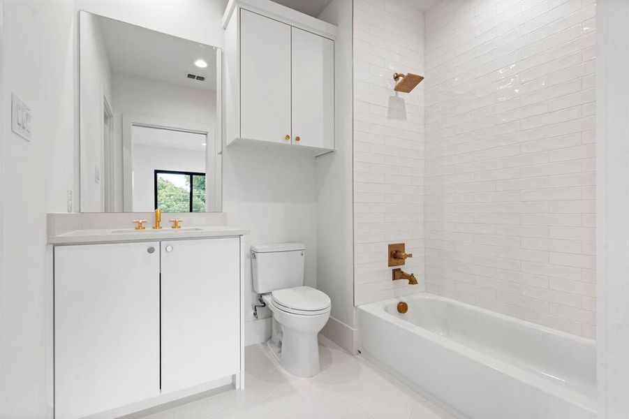Full bathroom featuring vanity, shower / bath combination, and tile patterned floors Full bathroom featuring vanity, shower / bath combination, and tile patterned floors