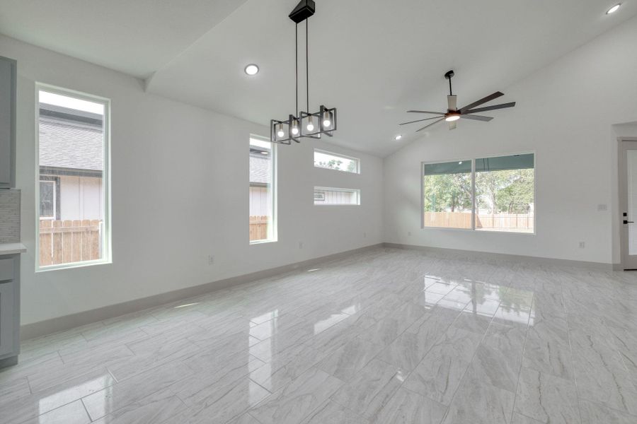 Dinning area with healthy amount of natural light, high vaulted ceiling, recessed lighting, ceiling fan, and light marble finish floors Dinning area with healthy amount of natural light, high vaulted ceiling, recessed lighting, ceiling fan, and light marble finish floors