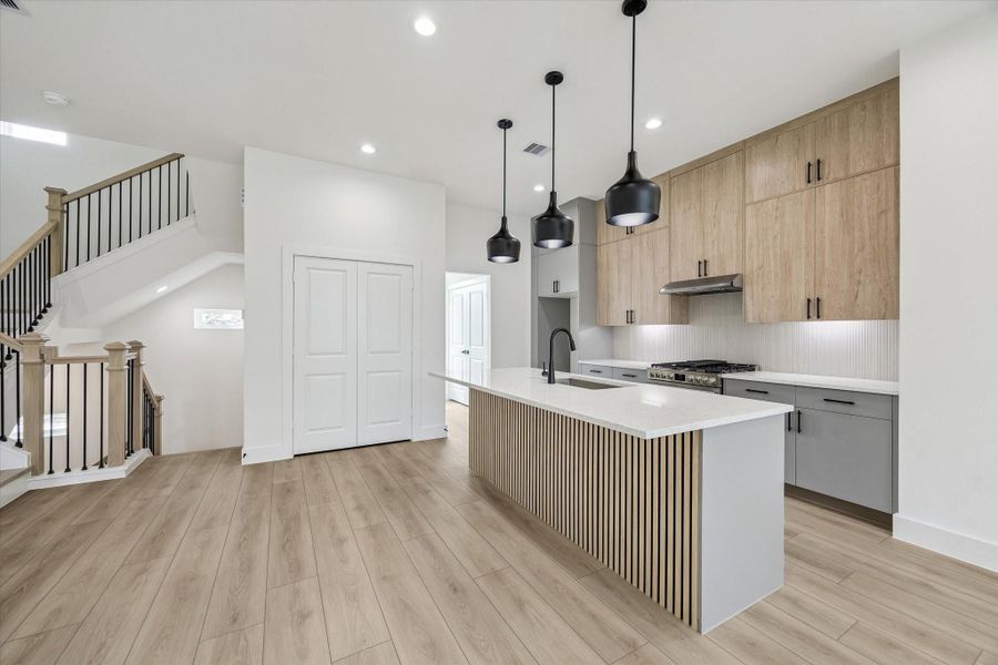 Kitchen-centered layout with island seating and seamless connection to living space Kitchen-centered layout with island seating and seamless connection to living space
