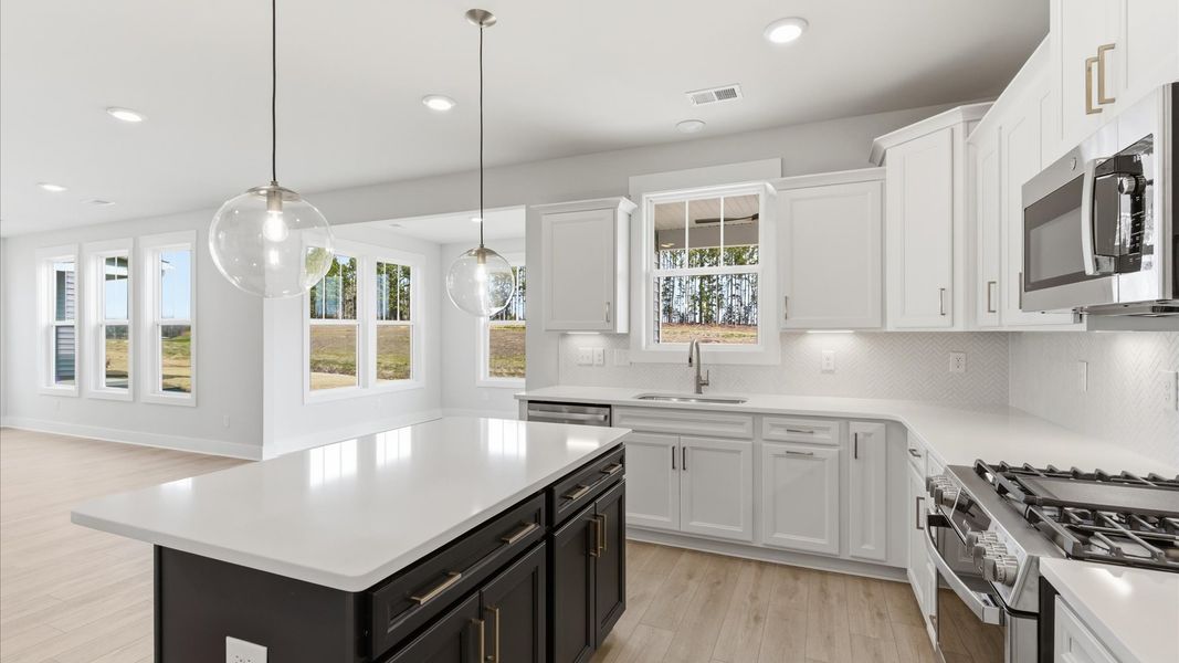 Elegant kitchen with center island and pendant lighting in this first-class DRB Homes design in Gray Court, SC