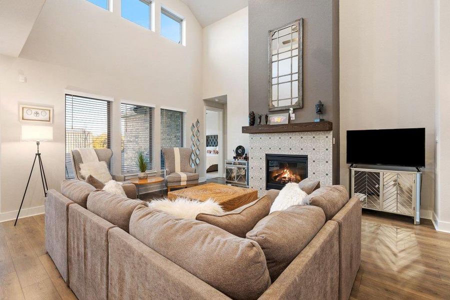 Warm, light-filled living area anchored by a modern fireplace.
