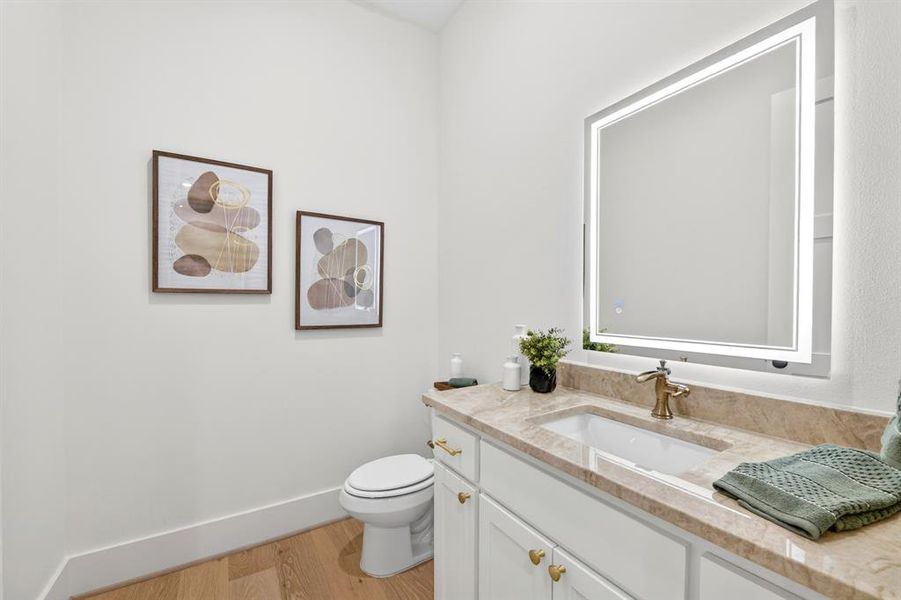 Good sized half bath for guests located off the front of the home