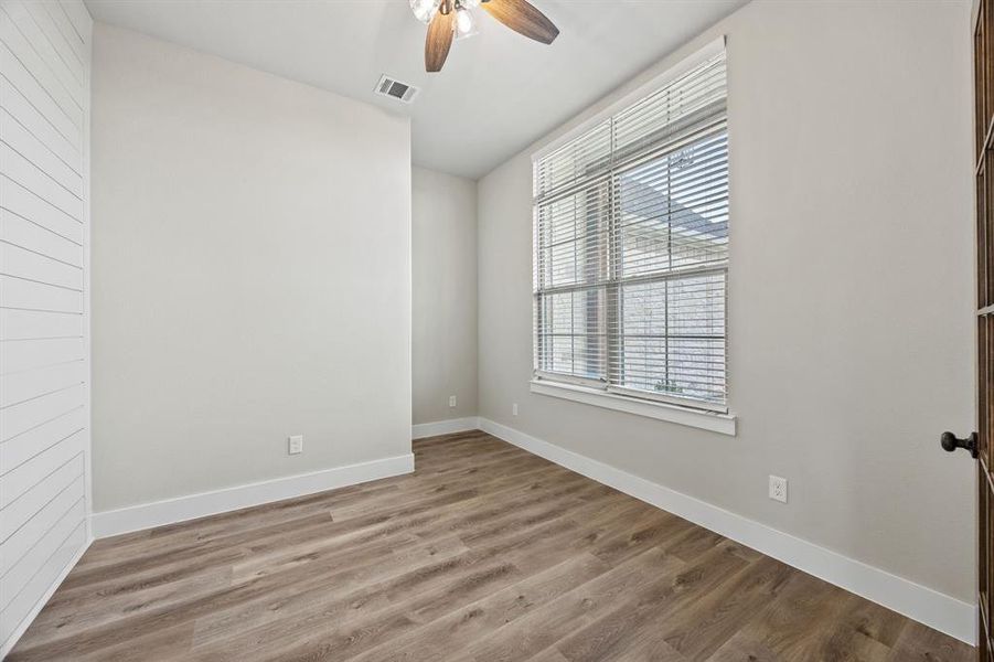 Unfurnished room featuring light wood-style flooring and ceiling fan Unfurnished room featuring light wood-style flooring and ceiling fan