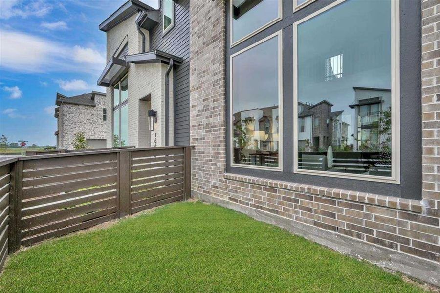 Fenced green space, perfect for pets, gardening, or relaxing outdoors.