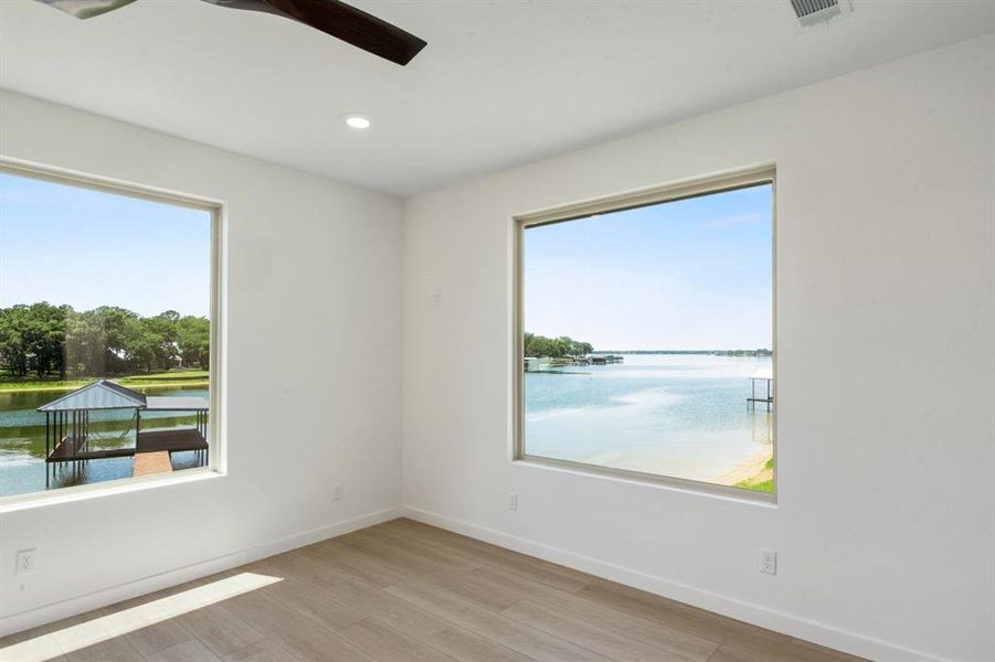2nd floor water front primary suite with access to patio & large bathroom.