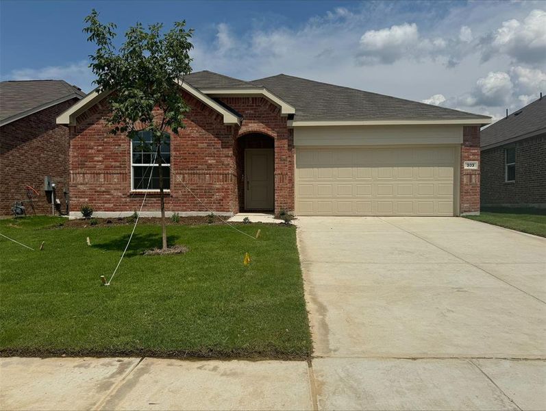 Single story home featuring a garage and a front lawn