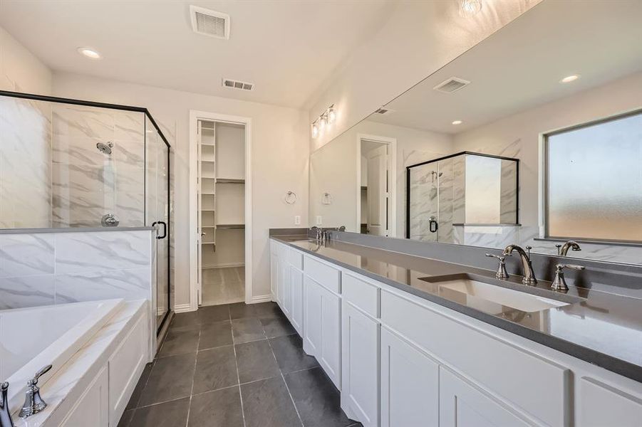 Bathroom with vanity, tile patterned floors, and plus walk in shower