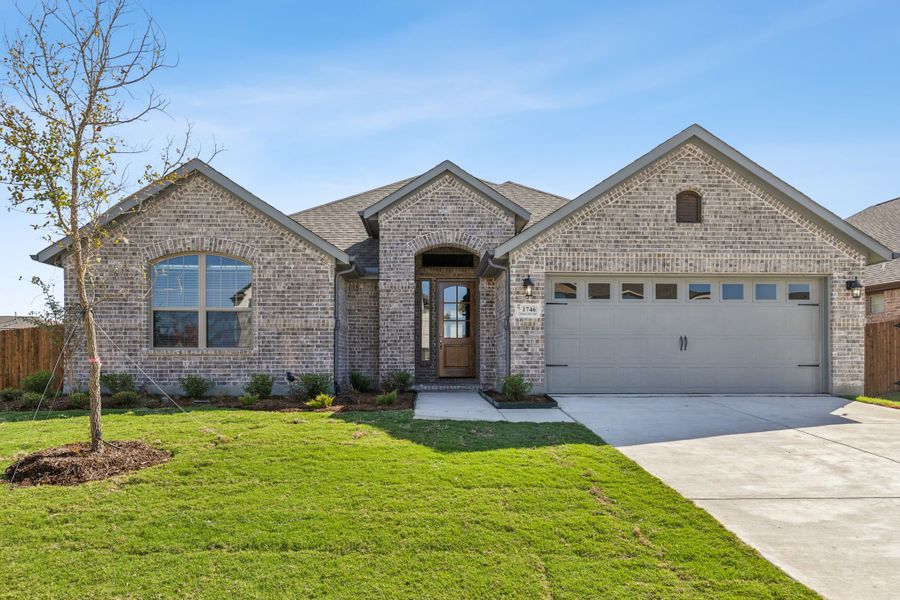 Front exterior of a new home in Oaks of North Grove, Waxahachie, TX, highlighting curb appeal (Image 1). Front exterior of a new home in Oaks of North Grove, Waxahachie, TX, highlighting curb appeal (Image 1).