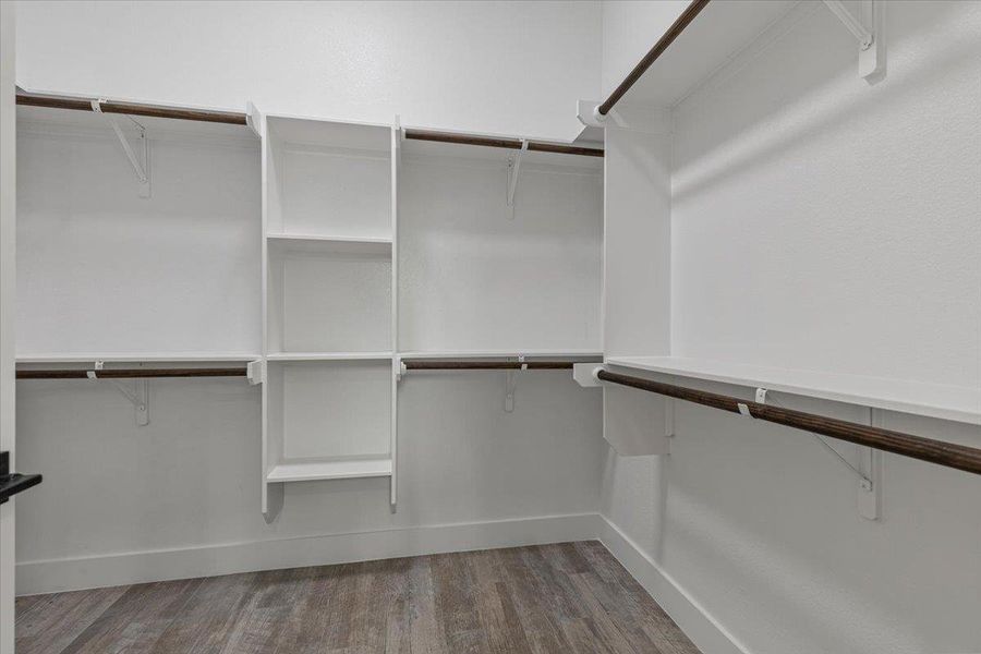 Ample closet space with integrated shelving and hanging rods for organized storage. Ample closet space with integrated shelving and hanging rods for organized storage.