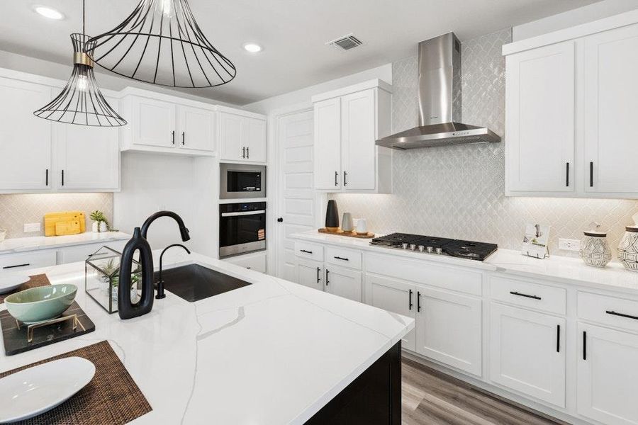 Kitchen featuring decorative backsplash, white cabinets, light stone countertops, and recessed lighting Kitchen featuring decorative backsplash, white cabinets, light stone countertops, and recessed lighting