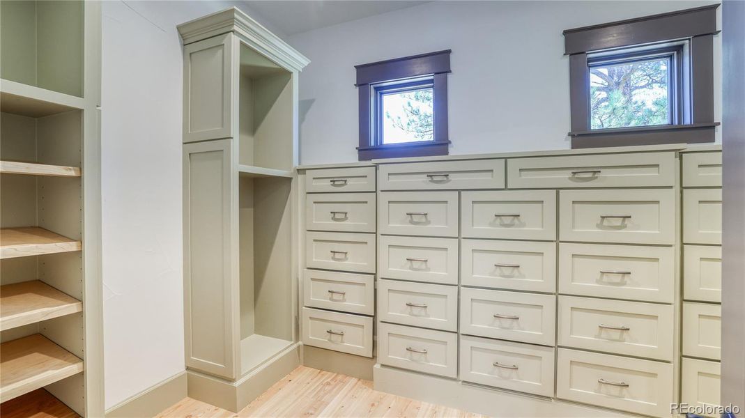 MAIN FULL CLOSET WITH BUILT-IN CABINETRY FOR OPTIMAL STORAGE