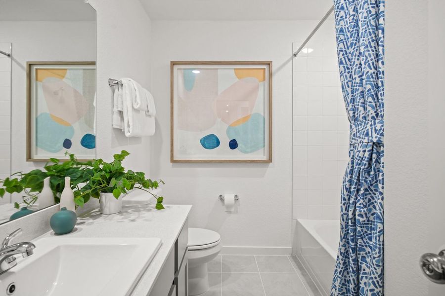 Bathroom in the Oak home plan by Trophy Signature Homes – REPRESENTATIVE PHOTO