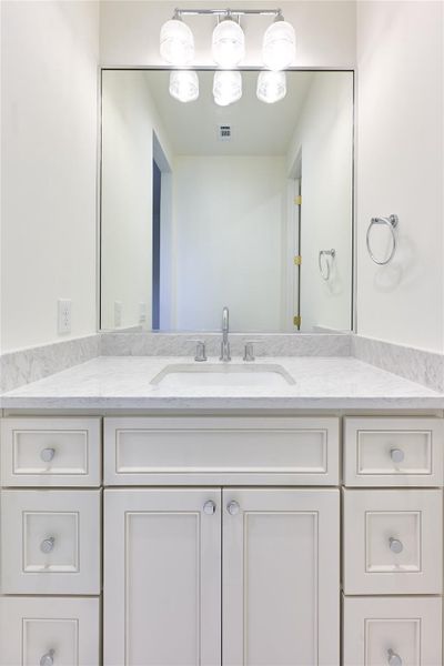 The Jack and Jill bathroom is thoughtfully designed with dual sinks, each featuring sleek quartz countertops, providing both style and practicality for shared use between the two bedrooms. The Jack and Jill bathroom is thoughtfully designed with dual sinks, each featuring sleek quartz countertops, providing both style and practicality for shared use between the two bedrooms.