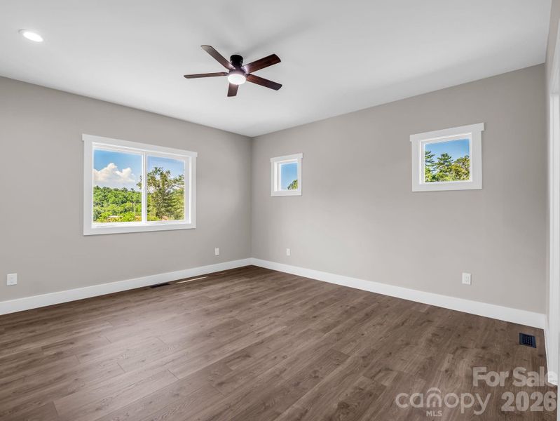 Primary bedroom, abundant natural light, hardwood floors Primary bedroom, abundant natural light, hardwood floors