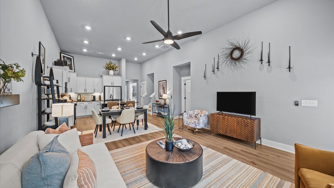 Eye-catching two-story family room with elegant trim, oversized windows, and elevated design