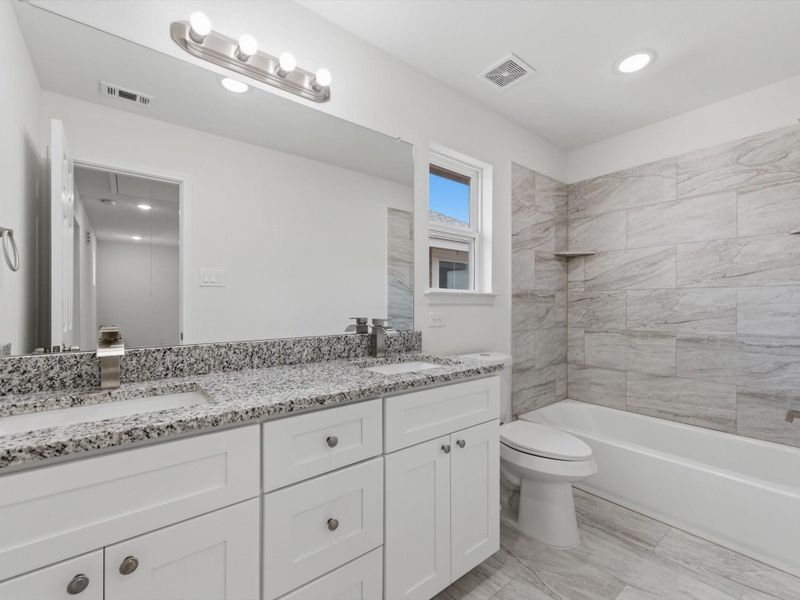 The full secondary bathroom makes everyday routines a breeze with dual sinks and abundant storage.