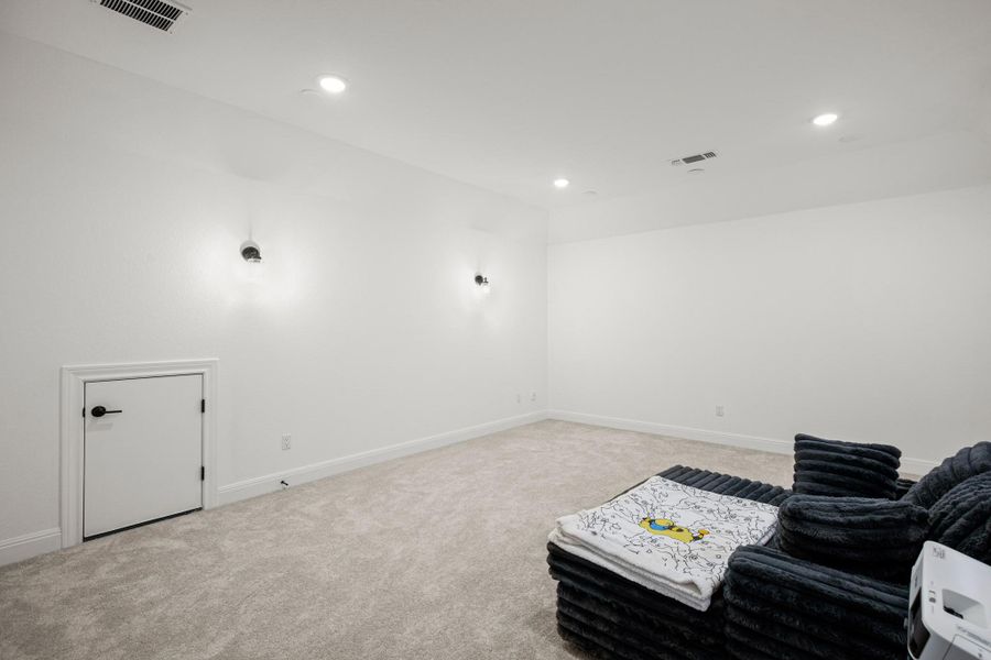 Cinema featuring light carpet and recessed lighting Cinema featuring light carpet and recessed lighting