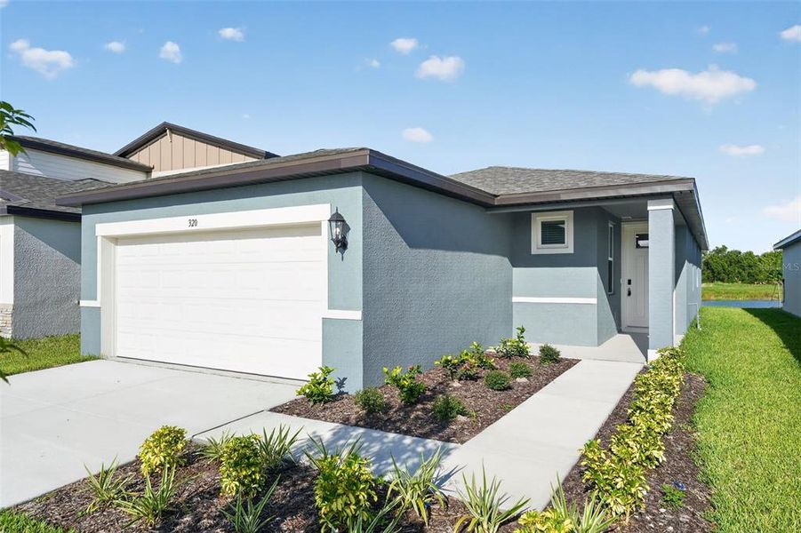 Front exterior of a new home in Magnolia Bay - Premier Series, Nokomis, FL, highlighting curb appeal (Image 26). Front exterior of a new home in Magnolia Bay - Premier Series, Nokomis, FL, highlighting curb appeal (Image 26).