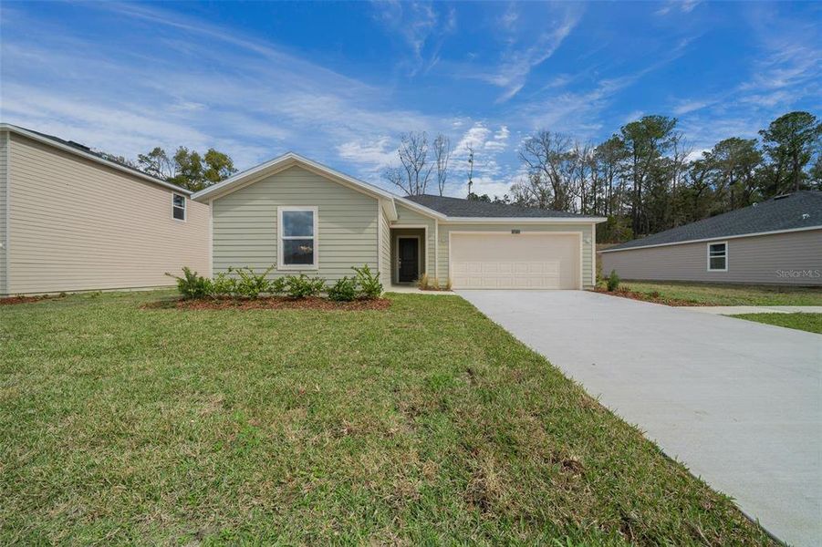 Front exterior of a new home in Tara Forest East, Alachua, FL, highlighting curb appeal (Image 23).