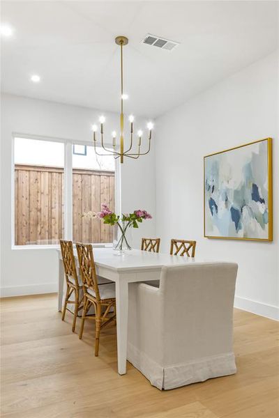 Dining room with an inviting chandelier and light wood-type flooring