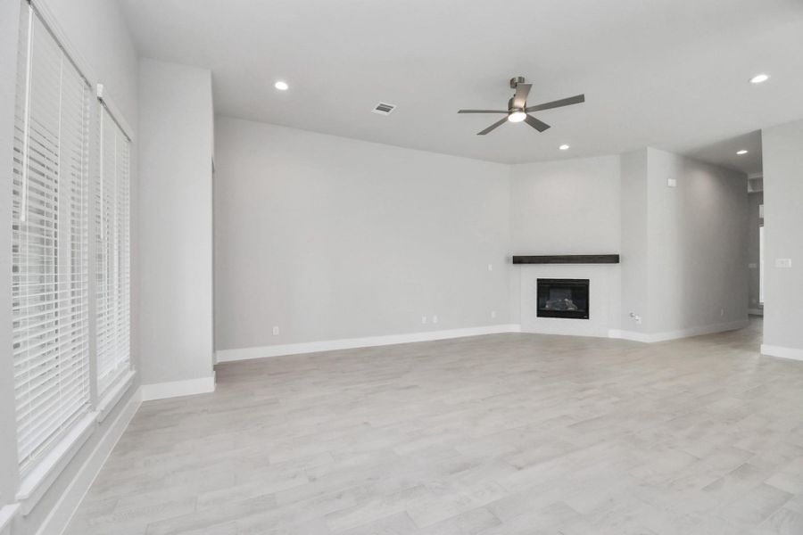 Take another glimpse into the heart of the home with this additional view of the family room—a sprawling space ready to accommodate all your gatherings. Sample photo of completed home with similar floor plan. Actual colors and selections may vary.