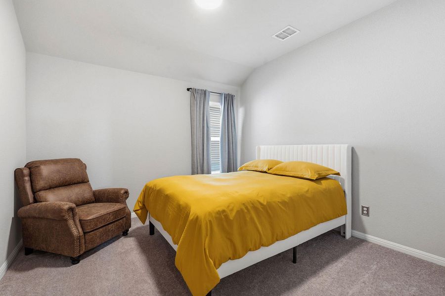 Bedroom with lofted ceiling and carpet Bedroom with lofted ceiling and carpet