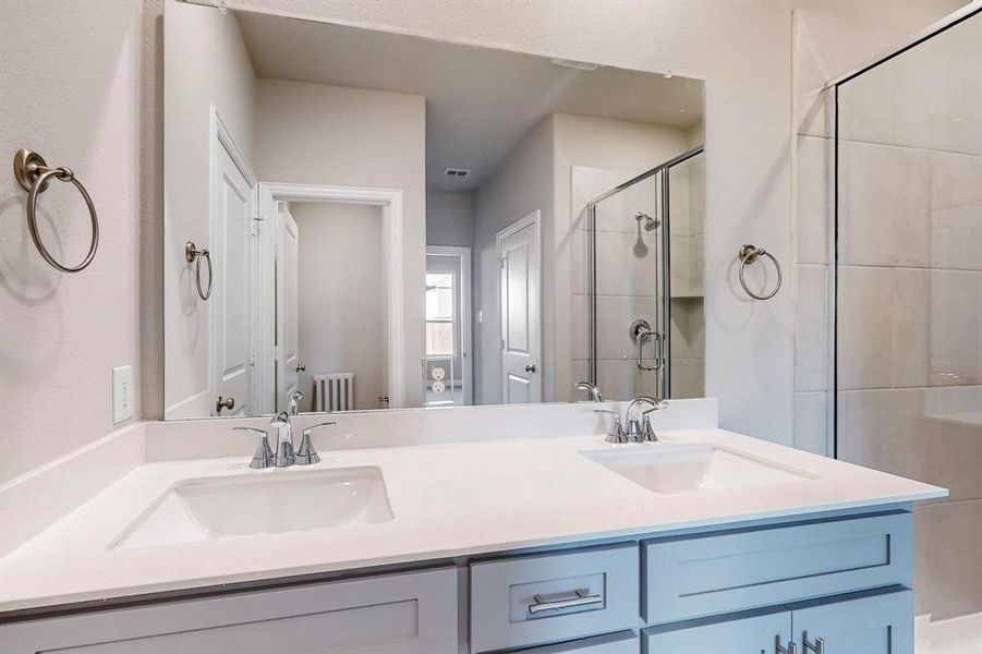 Bathroom featuring vanity and walk in shower