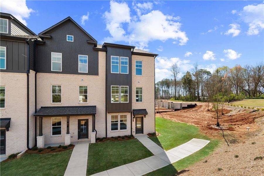Front exterior of a new home in Daybreak, Newnan, GA, highlighting curb appeal (Image 1). Front exterior of a new home in Daybreak, Newnan, GA, highlighting curb appeal (Image 1).