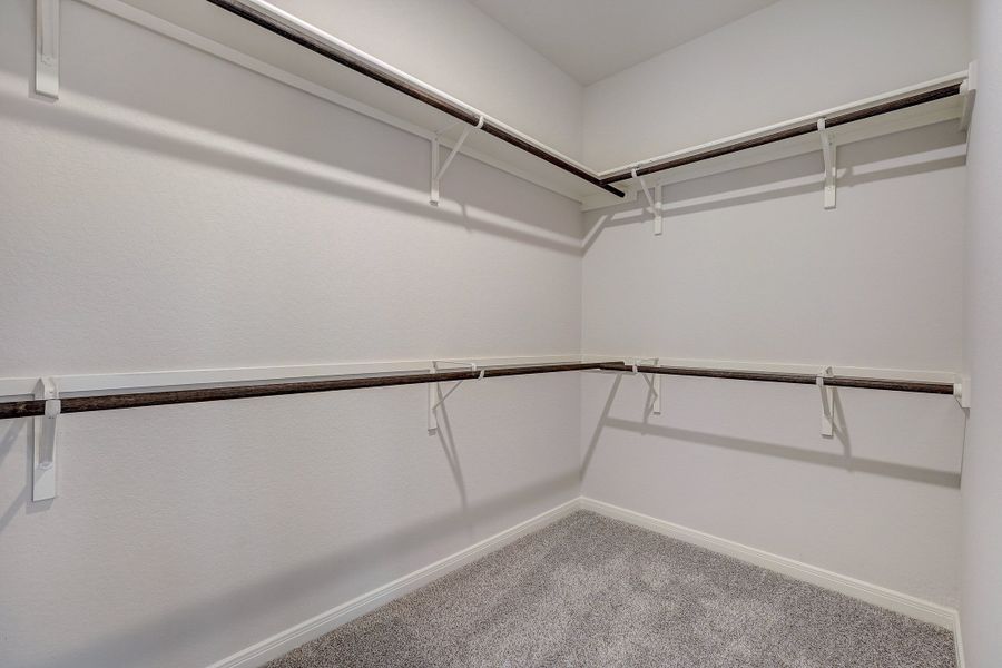 Primary suite walk-in closet in the Oleander floorplan at a Meritage Homes community.