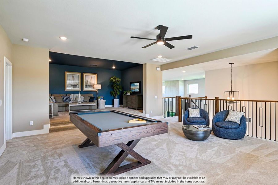 Upstairs game room with pool table, seating area, ceiling fan, and open staircase railing Upstairs game room with pool table, seating area, ceiling fan, and open staircase railing