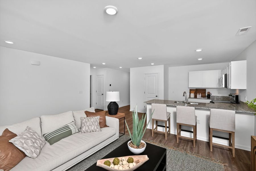 A large kitchen with a couch and a table.