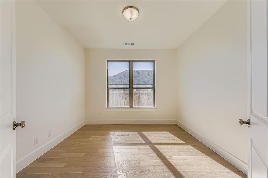 Spare room featuring light wood-style flooring and baseboards Spare room featuring light wood-style flooring and baseboards