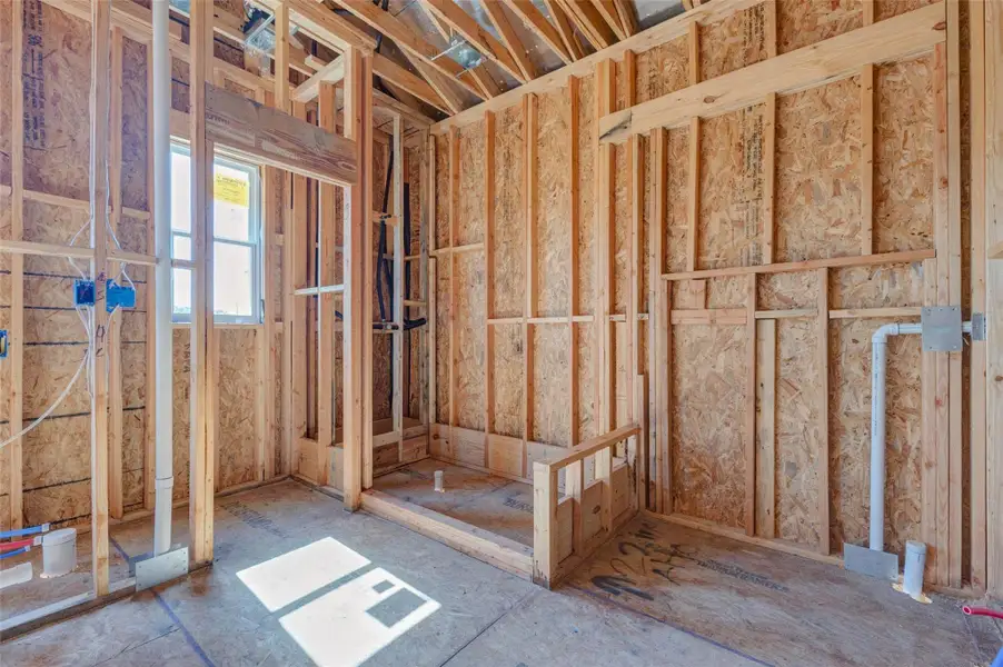 Framed bathroom area under construction, showing plumbing rough-ins, shower or tub placement, and defined wall locations. The visible framing and utility work provide a clear look at the future bath layout while demonstrating the detailed progress being made before drywall, tile, cabinetry, and fixtures are installed. Framed bathroom area under construction, showing plumbing rough-ins, shower or tub placement, and defined wall locations. The visible framing and utility work provide a clear look at the future bath layout while demonstrating the detailed progress being made before drywall, tile, cabinetry, and fixtures are installed.