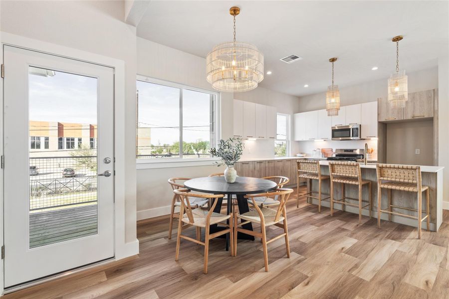 A custom chandelier anchors the dining area, adding warmth and a subtle focal point that elevates the space without overpowering it.