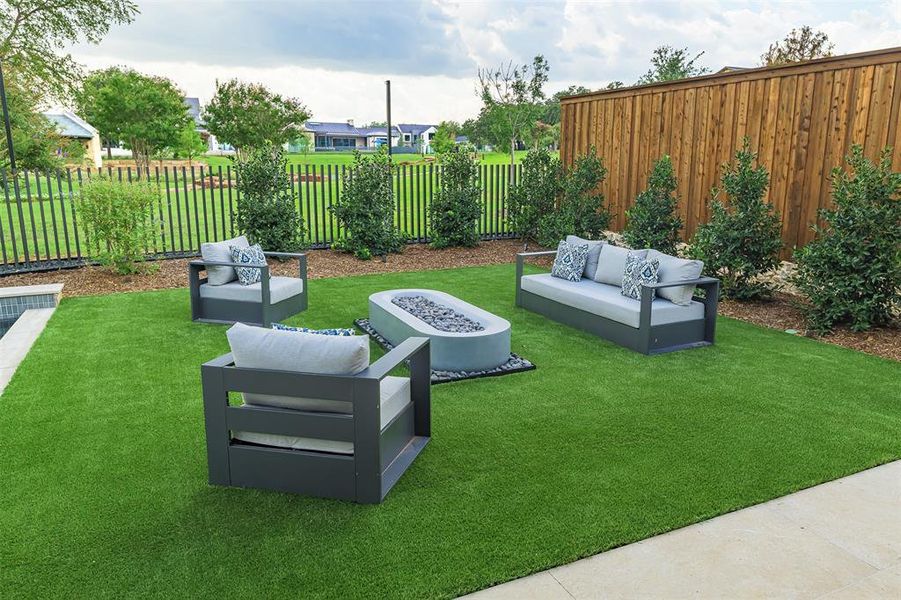 Automated gas firepit and full artificial turf backyard