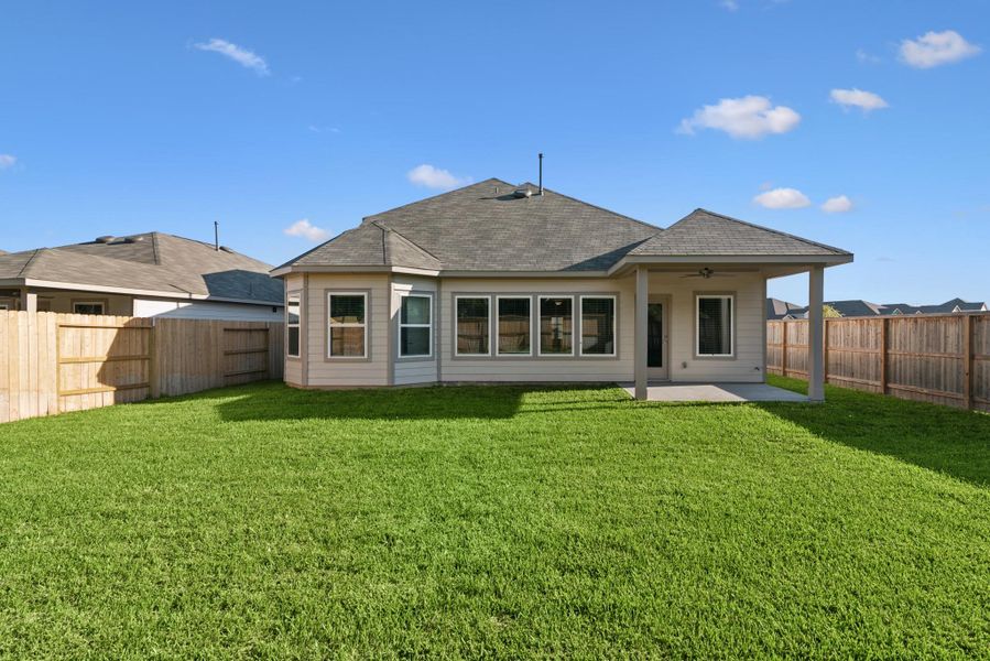 Exterior details and patio area of a home in Pinewood at Grand Texas, New Caney (Image 13).