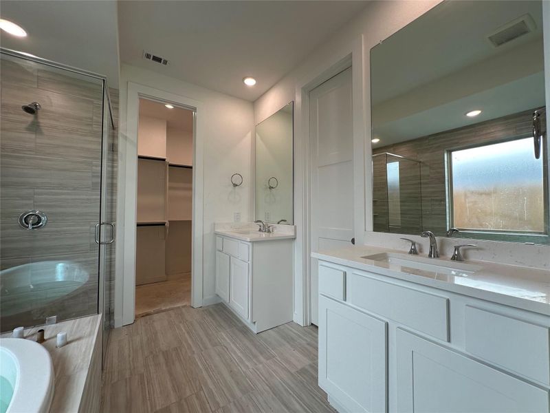 Unwind in this beautifully appointed primary bathroom, featuring a sleek glass-enclosed shower with a stylish tile floor and a luxurious drop-in tub surrounded by elegant tile. Your personal spa escape awaits! Unwind in this beautifully appointed primary bathroom, featuring a sleek glass-enclosed shower with a stylish tile floor and a luxurious drop-in tub surrounded by elegant tile. Your personal spa escape awaits!