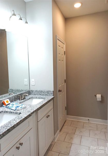 En-suite Bath with double sinks and linen closet